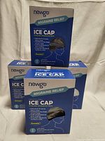 Four boxes of Newgo Migraine Relief Ice Caps stacked together.