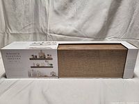 Boxed set of 2 wooden floating shelves by Sheffield Home, showing packaging with images and text describing the product and dimensions.