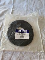 Photo of one roll of ULINE Velcro Straps in sealed clear plastic packaging showing label with model S-13671BL