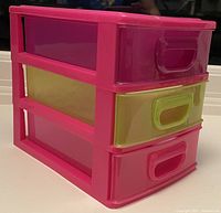 front angled view showing pink plastic organizer with three colored drawers