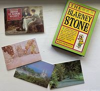 Group shot showing both books and three postcards