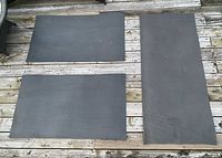 Three grey foam rug underlays laid out to show sizes