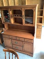 Front view of vintage buffet and hutch showing drawer and cabinet details on buffet and glass doors on hutch.