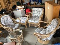 Full view of two swivel chairs, armchair, ottoman, two side tables