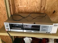 Front and top angled view of the Sony TC-FX45 cassette deck showing the cassette compartment, control panel, and connected power cord.