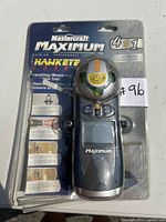 Front view of the Mastercraft Maximum Hawkeye 4-in-1 laser level and measuring tool in original sealed blister packaging showing the device and branding.