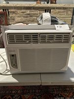 Front view of the Noma window air conditioner showing the control panel and air vents.