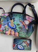 Front view of the purse and wallet showing the detailed hand painted sea turtle and underwater scene on the genuine leather surfaces.