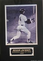 Framed black-and-white photograph of Reggie Jackson in a New York Yankees uniform with signature and nameplate.