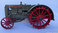 Side view of die cast CASE tractor showing detailed engine and red spiked rear wheels
