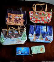 Six-piece lot of winter-themed handbags and wallets arranged on a dark surface showing all items in group.