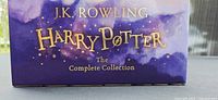 Purple box with gold lettering 'J.K. Rowling Harry Potter The Complete Collection'