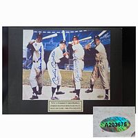 Full view of black-mounted photo with four autographs and gold-tone nameplate