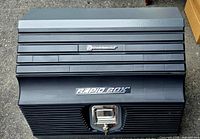 Black Powerbuilt Rapid Box slant-front toolbox closed, showing embossed Rapid Box logo and metallic key lock latch