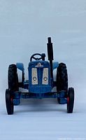 Front view of blue Fordson Super Major die-cast tractor highlighting its detailed grill and exhaust pipe.