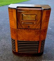 Front view of Majestic console radio showing wood veneer cabinet, AM dial and lower grille.