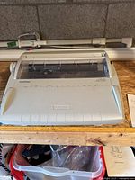 Front view of Brother GX-6750 electronic typewriter on wooden surface, showing overall device.