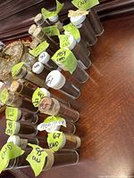 View showing multiple clear plastic coin tubes with white caps labeled with various years ranging from 1951 to 1967, each filled with Canadian pennies sorted by date.