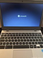 Open Samsung Chromebook showing Chrome OS boot screen and QWERTY keyboard.