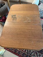 Top view image of the old oak table showing worn surface with visible marks and discoloration.