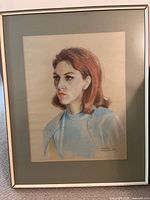 Framed pastel portrait of a woman with red hair, signed by artist, measuring 33x25 cm