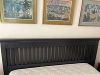 Full view of the Shaker style queen size wooden headboard showing dark stained vertical slats and frame.