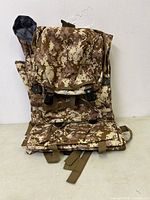 Front view of large army hiking backpack with digital desert camo pattern, showing front buckles and multiple compartments.