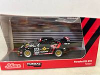 Front view of boxed Porsche 911 GT2 Taisan model showing car inside clear plastic and red base with branding.