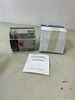 Dual Power Automatic Transfer Switch device with user manual and original box visible, placed on flat surface.