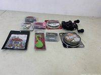 Overview of all fishing accessories including lure packages, fork spoon, reel, and line.