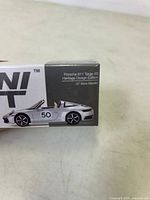 Front side of the mini GT diecast model box showing text Porsche 911 Targa 4S Heritage Design Edition GT Silver Metallic with image of the model car.