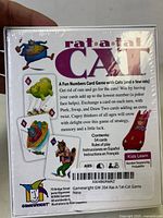 Back of Rat-a-tat Cat game box showing game description, contents including 54 cards and rules of play, and Gamewright branding.