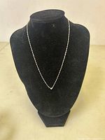 Front view of fine sterling silver chain necklace displayed on black velvet bust.