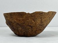 Side view showing carved wooden bowl profile and grain