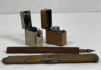 All four items: two inkwells open showing interiors, wooden pen, folded ruler