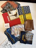 All seven silk handkerchiefs laid out to show variety of colours and patterns