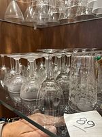 Shelf of assorted etched stemware and one tumbler