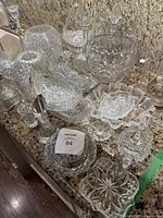 Multiple clear cut glass pieces displayed on countertop