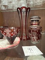 Tall vase, lidded canister, one conical bowl visible