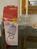 Photo of Omron large adult blood pressure cuff in original box with product details.