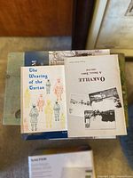 Top-down image of four mystery books stacked together showing their covers