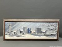 Framed cityscape oil painting showing the full artwork and wooden frame.