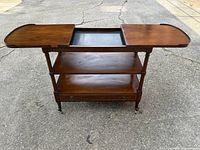 Full view of table with drop leaves extended and central tray in place