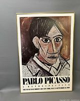 Framed Pablo Picasso museum poster showing stylized portrait and exhibition details
