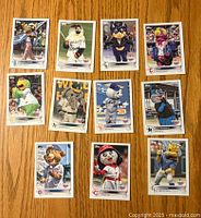 Front side of 11 Topps baseball cards showing various MLB mascots in different poses and attire