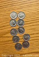 Top view of the reverse side of all 12 Canadian nickels showing the caribou design.