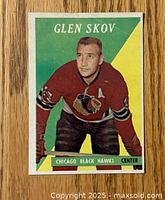 Front side of the 1958-59 Topps Glen Skov hockey card showing the player in Chicago Black Hawks uniform against green and yellow background.