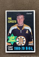Front of the 1970-71 O-Pee-Chee Phil Esposito hockey card showing portrait of Phil Esposito in Boston Bruins jersey, text indicating his all-star status and position as center.