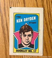Front cover of the Ken Dryden hockey booklet featuring an illustrated portrait of Ken Dryden with colorful background.