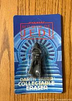 Front view of sealed Darth Vader eraser in blue Return of the Jedi packaging with stairs background and red logo.